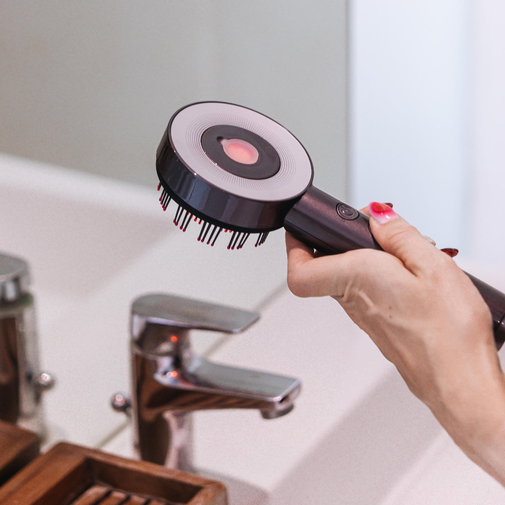 Person using a hair brush in a bathroom setting
