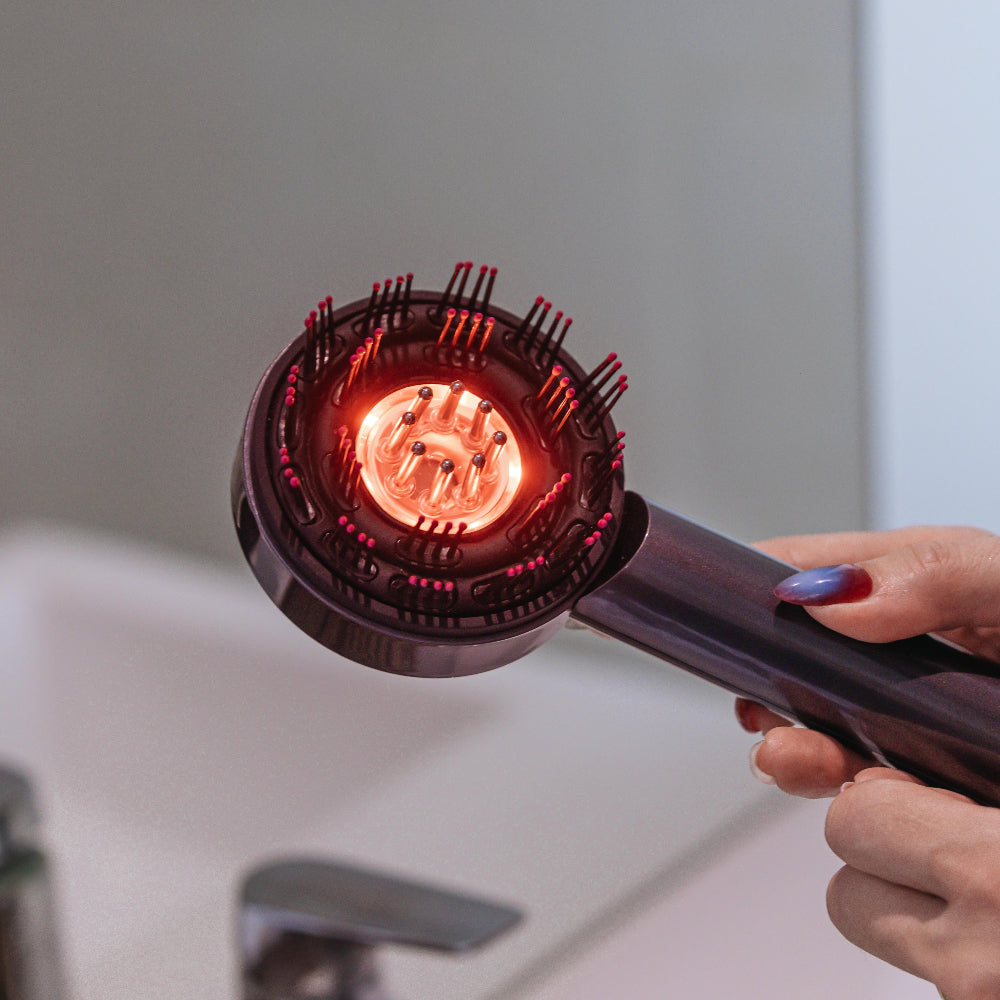 Handheld device with a red light held over a sink.